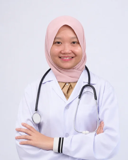 Dr. Nur Syuhadah binti Omar memakai kot doktor bersama stetoskop